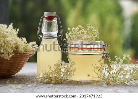 Similar – Image, Stock Photo Elder flower syrup ingredients: Elder branch, lemon and sugar in glass jar
