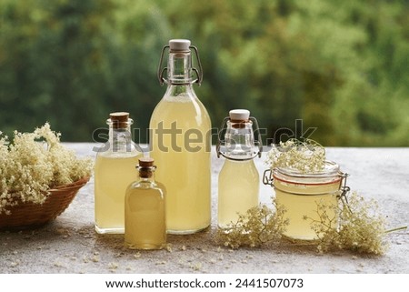 Similar – Image, Stock Photo Elder flower syrup ingredients: Elder branch, lemon and sugar in glass jar