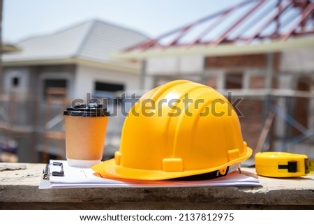 Construction concepts. Yellow safety helmets and tape measure on the engineering desks. Hard safety wear helmet for safety and protect before hard working at construction site Photo stock © 