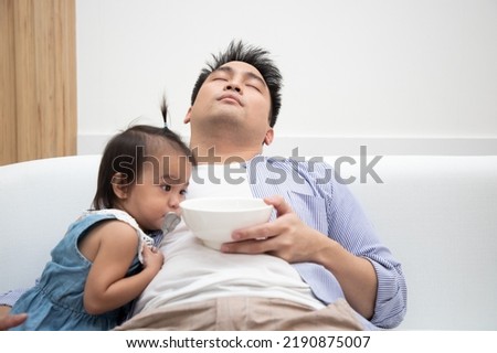 Similar – Image, Stock Photo Single dad feeding his baby who is sat in a high chair