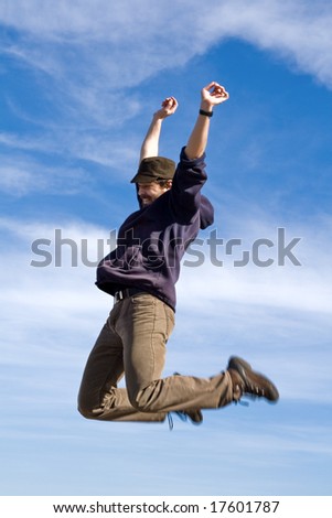Happy man jumping high into the air with blue sky as background