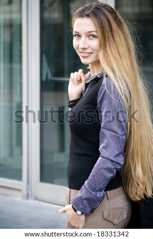 Beautiful businesswoman in front of office building