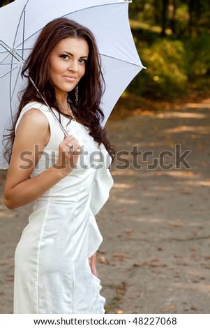 Sexy elegant young woman with umbrella outdoor