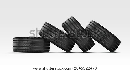 Car tire with cast chrome wheel. A stack of car tires lie on their sides on top of each other. 4 rubber wheels for summer and winter on a white background.