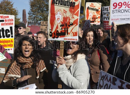 THE HAGUE - OCTOBER 15:  An unidentified women holding banners of Socialist party shouting during the Occupy protest on October 15, 2011 in The Hague, The Netherlands.