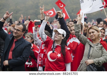 THE HAGUE - OCTOBER 30: Unidentified men and women of Turkish origin making the Grey Wolves hand sign during a protest against the Kurdistan Workers Party on October 30, 2011 in The Hague.