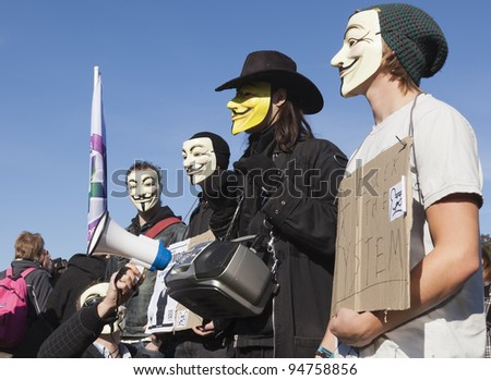 THE HAGUE – OCTOBER 15: Four masked members of Anonymous protesting during the Occupy protest on October 15, 2011 in The Hague, The Netherlands.