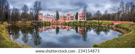 Orange manor house with reflection in the pond