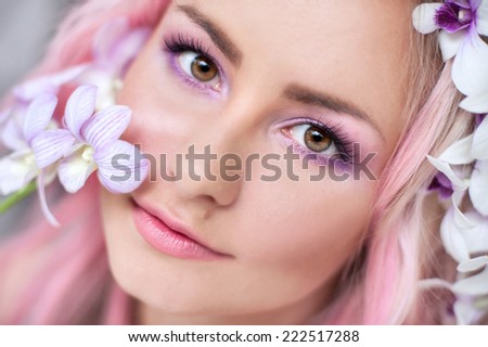 tender girl with pink hair in these orchids, close-up,Beautiful Fashionable Woman Posing Fashion portrait of a beautiful young blond woman.