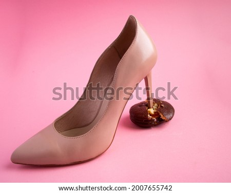 high thin heel of  womans leather beige shoe breaks chocolate sponge cake with filling into pieces and crumbs. concept of proper healthy nutrition rejection of unhealthy and sweet, highcalorie foods. Сток-фото © 