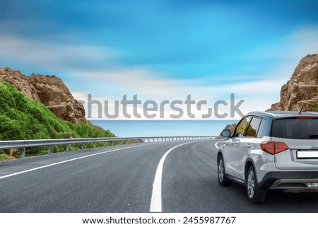 Similar – Image, Stock Photo Traveler driving car on country road through winter forest