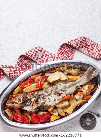 prepared fish with vegetables on metal plate