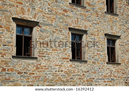 Three windows in stone wall. All windows opened and all are the same.
