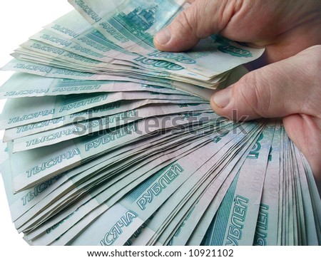 The hands holding many of the Russian banknotes