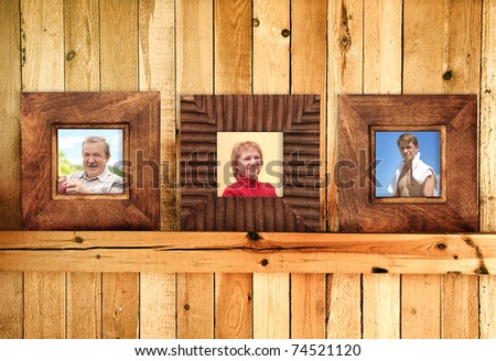 Three frames with family photos on wooden wall