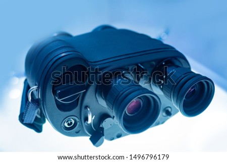 Binoculars with a range finder. Binoculars with night vision device. Observation from a distance. Advanced equipment for remote observation. Military Commune. Spy's equipment.Ammunition for the hunter Stock foto © 