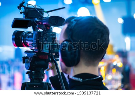 Video operator. Videography.Filming.A man is shooting a video.The work of a videographer. Shooting with a professional camera with a tripod. A man shoots on a professional video camera.Videographer Stock foto © 