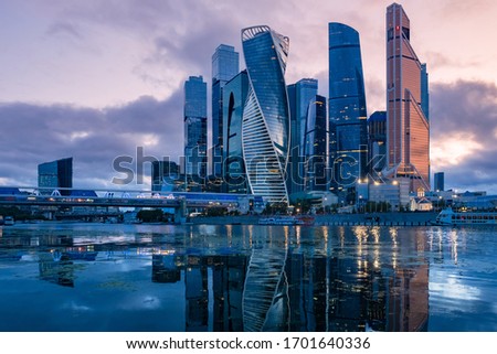 Russia. Skyscrapers in the center of Moscow. High-rise buildings in the capital of the Russia. Complex Moscow-city against the gray sky. Skyscrapers and a glazed bridge over the Moscow river.