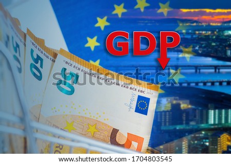 Inscription GDP near the night city. Economic situation in European Union. Money as a symbol of the economy. Euro Money close up. Reduction in GDP. Gross domestic product decline. Euro zone crisis 商業照片 © 