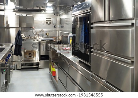 Restaurant kitchen with chrome equipment. Kitchen of working restaurant without people. Equipment for fast food restaurant. Equipment for confectionery shop. Professional kitchen furnishing for cafe