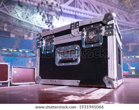 Box rack for transportation of concert equipment. Wardrobe trunk on background of concert venue. Rack wardrobe trunk on stage. Concept - sale of rack cases for concert equipment. Musical equipment