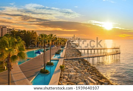 Sunset in Cyprus Limassol. Panorama of  Cyprus Limassol resort. Limassol promenade at sunset. Cyprus resort on sunset background. Tourist places on Mediterranean coast.