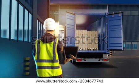 Logistic work. Container truck. Man logistician with his back to camera. Unloading truck in warehouse. Logistician with laptop. Man near industrial buildings. Truck with boxes on pallets Foto stock © 