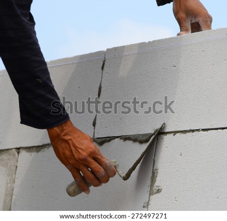 Construction of the wall of white brick.
