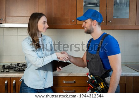 Similar – Image, Stock Photo Plumber signs a contract for the services in the kitchen