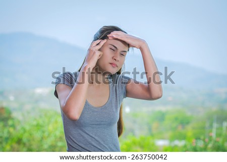Young woman in pain with closed eyes with headache