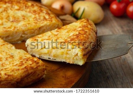 Spanish omelette with potatoes and onion, typical Spanish cuisine. Tortilla espanola. Rustic dark background Сток-фото © 