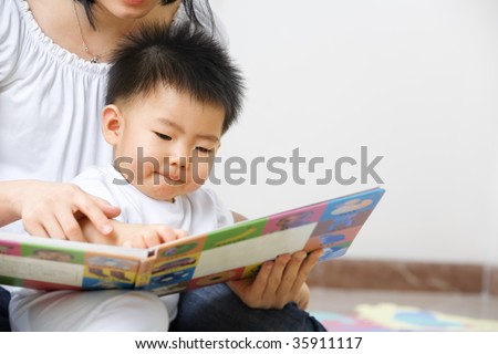 Asian mother tutoring her son for early education