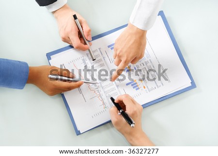 group of people examining economic booming statistic