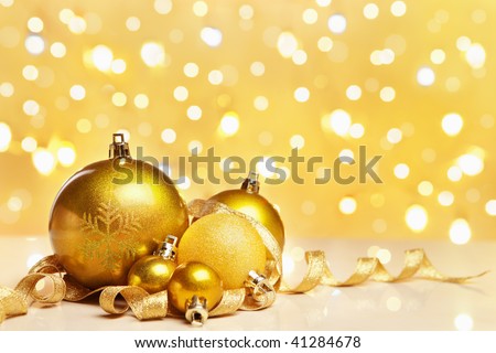 Golden Christmas ornaments with blur light on background