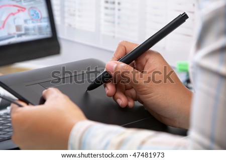 Graphic designer working using pen tablet in office