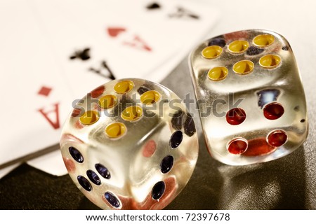 Two dices and four kind of ace cards on the table