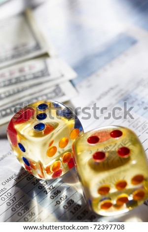 Two dices and dollar bills on stock data sheet for a concept of risk on stock exchange