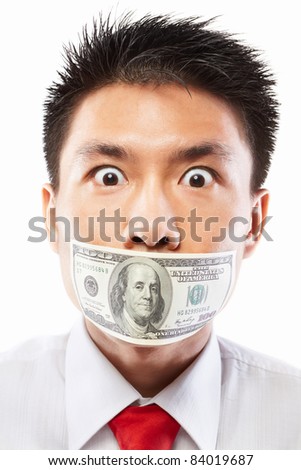 Chinese young man with his mouth sealed by a hundred dollar bills for bribe concept