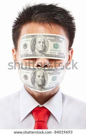 Chinese young man with his mouth an eyes each sealed by two hundred dollar bills for bribe concept