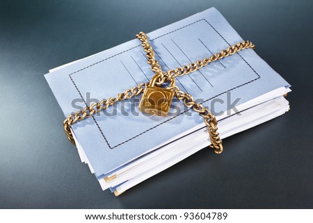 Stack of files and folder being surrounded by locked chain