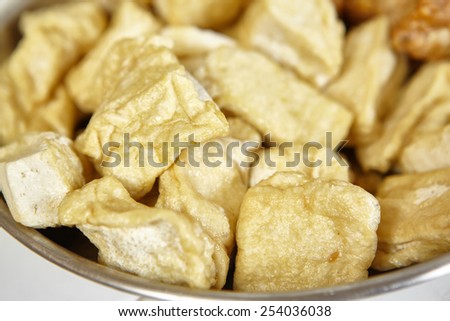 Fried tofu on a plate as ingredient for cooking