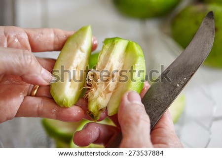 Peeling and cutting ambarella fruit or known as kedondong in Indonesia