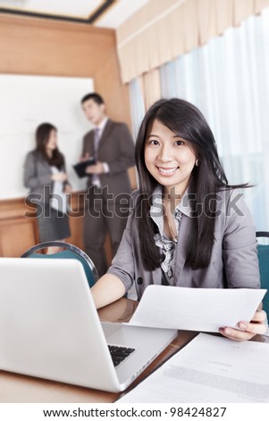 Chinese businesswoman smiling to the camera in the office