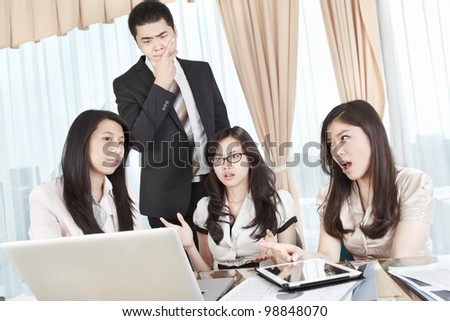 Group of businesswomen having discussion with a manager watching from behind
