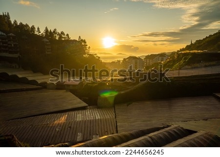 Similar – Image, Stock Photo Lights over the city. Two upward shining white stripes in the blue sky above the houses.