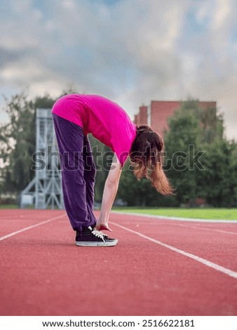 Similar – Image, Stock Photo Focused sportswoman hanging on bar while working out in gym