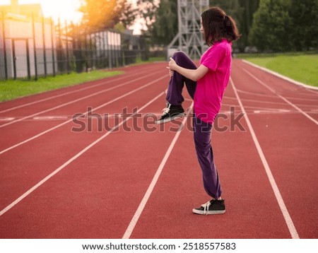 Similar – Image, Stock Photo Focused sportswoman hanging on bar while working out in gym