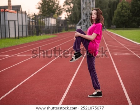 Similar – Image, Stock Photo Focused sportswoman hanging on bar while working out in gym