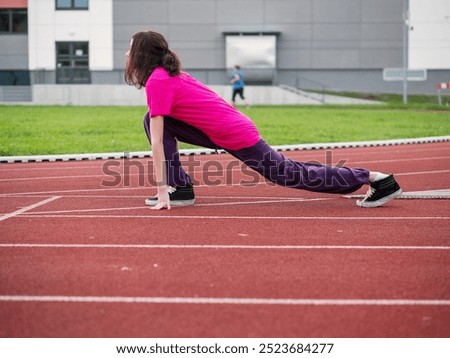 Similar – Image, Stock Photo Focused sportswoman hanging on bar while working out in gym