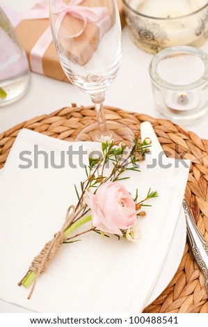 Festive table setting with pink flowers and candles